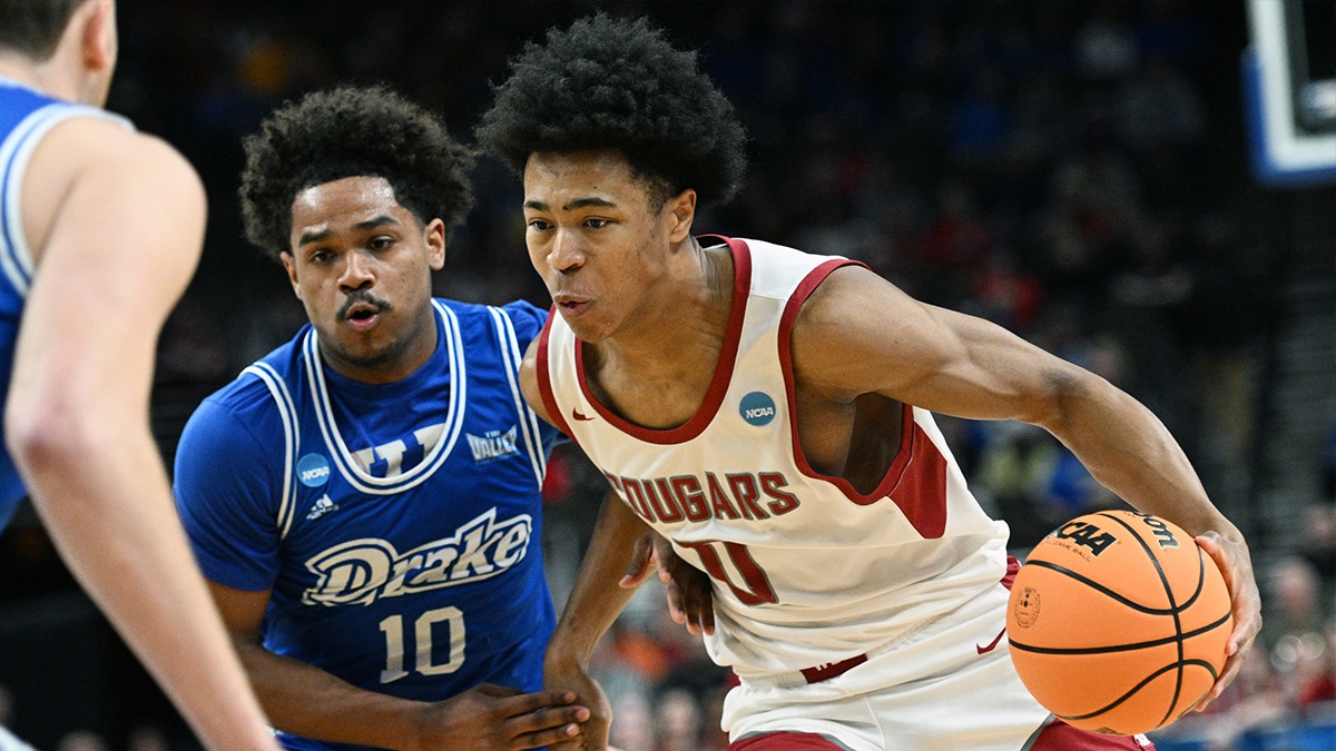 Washington State Cougars forward Jaylen Wells (0) drives against Drake Bulldogs guard Atin Wright (10) in the first half in the first round of the 2024 NCAA Tournament at CHI Health Center Omaha.
