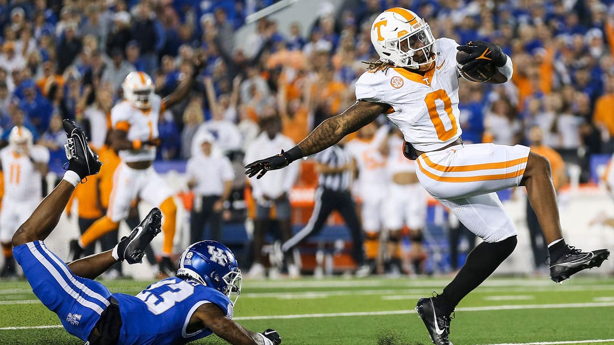 Tennessee Volunteers running back Jaylen Wright (0) dodges Kentucky Wildcats defensive back Andru Phillips (23) to strike first with a Volunteer touchdown early in the first quarter