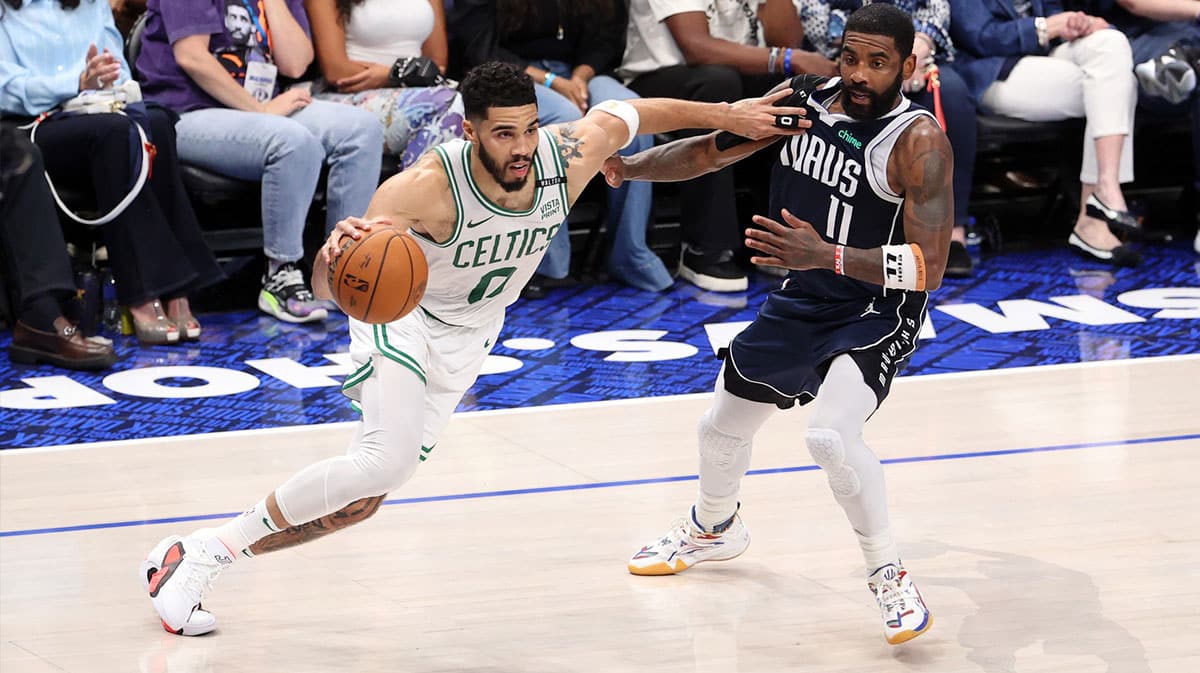 Boston Celtics forward Jayson Tatum (0) drives to the basket against Dallas Mavericks guard Kyrie Irving (11) during the second quarter during game four of the 2024 NBA Finals at American Airlines Center.
