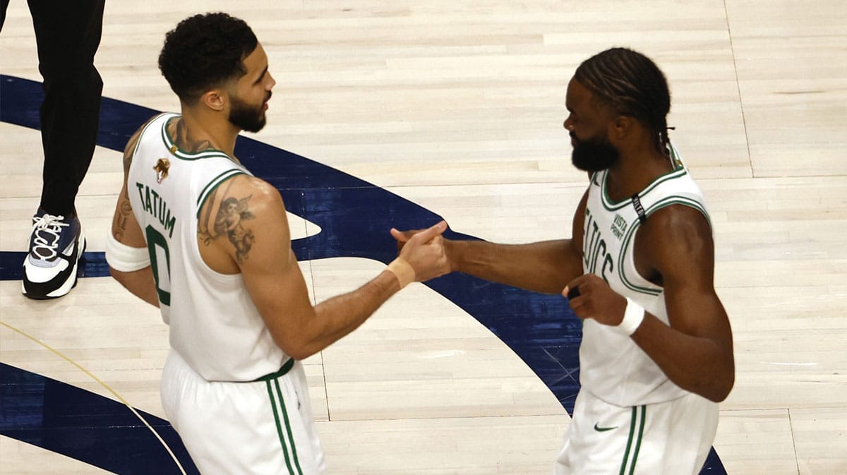 Boston Celtics forward Jayson Tatum (0) and guard Jaylen Brown (7) celebrate after defeating the Dallas Mavericks in game three of the 2024 NBA Finals at American Airlines Center.