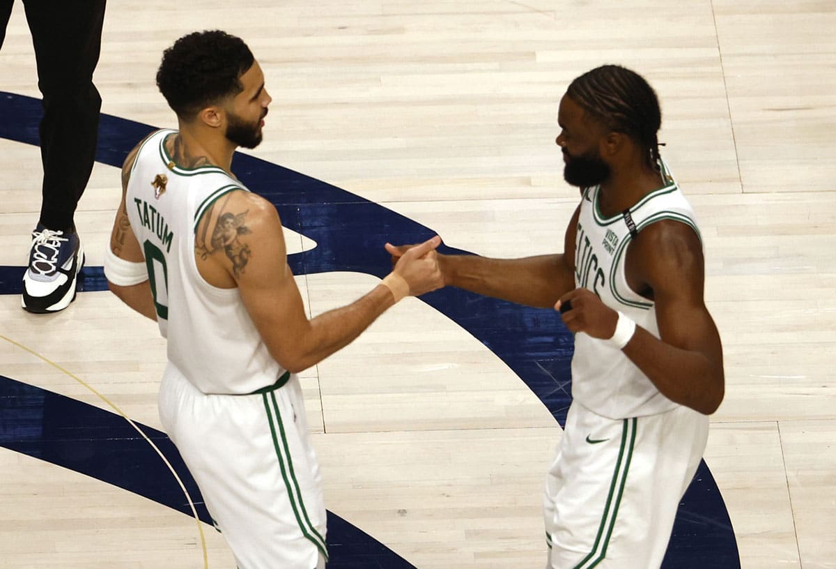 Boston Celtics forward Jayson Tatum (0) and guard Jaylen Brown (7) celebrate after defeating the Dallas Mavericks in game three of the 2024 NBA Finals at American Airlines Center. 