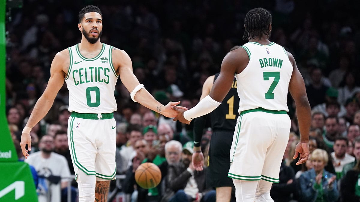 Boston Celtics forward Jayson Tatum (0) and guard Jaylen Brown (7) react after a play against the Cleveland Cavaliers in the first quarter during game two of the second round for the 2024 NBA playoffs at TD Garden