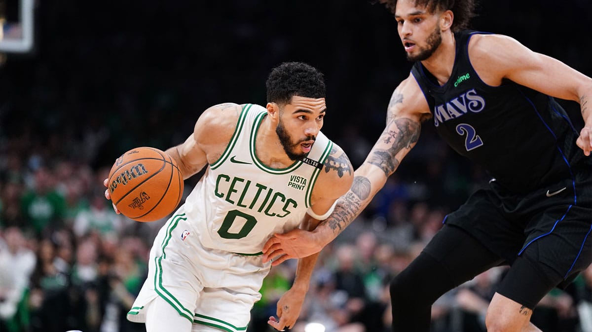 Boston Celtics forward Jayson Tatum (0) controls the ball against Dallas Mavericks center Dereck Lively II (2) in the third quarter during game one of the 2024 NBA Finals at TD Garden.