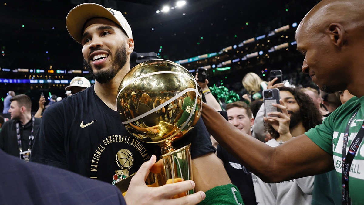 Boston Celtics forward Jayson Tatum (0) is greeted by Ray Allen as he walks off the court with the trophy as he celebrates winning the 2024 NBA Finals against the Dallas Mavericks at TD Garden