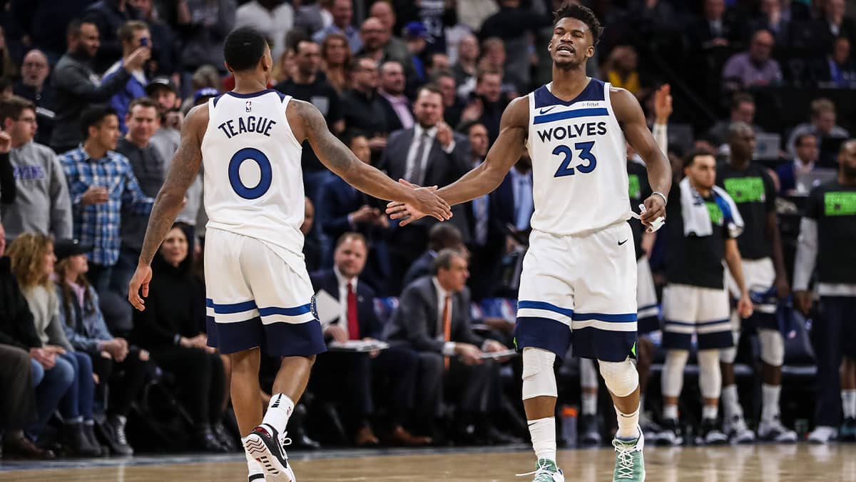 Minnesota Timberwolves guard Jimmy Butler (23) celebrates with guard Jeff Teague (0) during the fourth quarter against the \e at Target Center. 