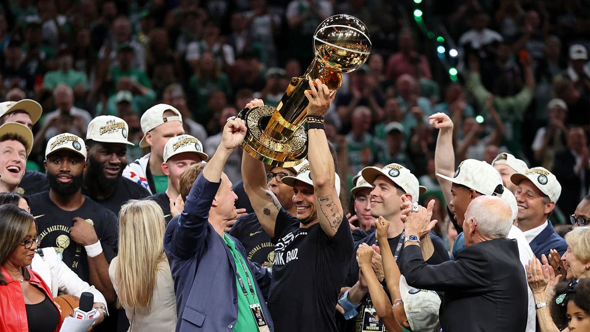 Boston Celtics head coach Joe Mazzulla holds up the trophy as he celebrates after winning the 2024 NBA Finals against the Dallas Mavericks at TD Garden.