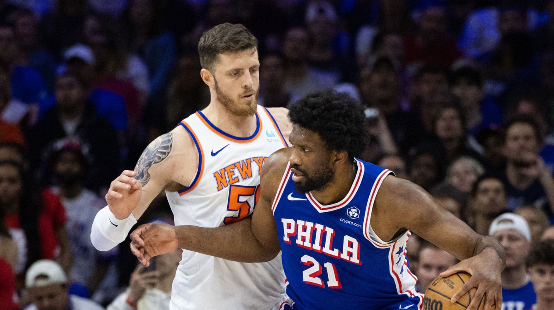 Philadelphia 76ers center Joel Embiid (21) controls the ball against New York Knicks center Isaiah Hartenstein (55) during the first half of game six of the first round for the 2024 NBA playoffs at Wells Fargo Center. 