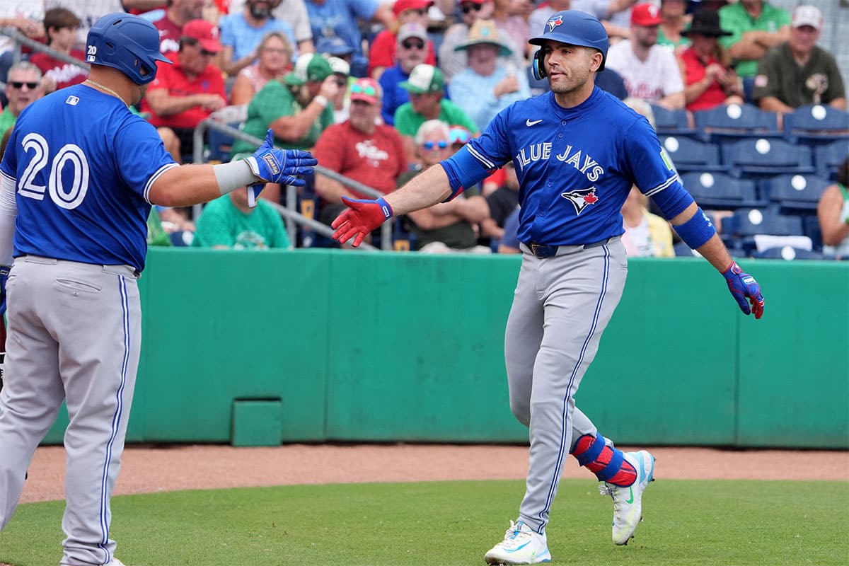 Toronto Blue Jays infielder Joey Votto (37) is congratulated after hitting a home run against the Philadelphia Phillies during the first inning at BayCare Ballpark.