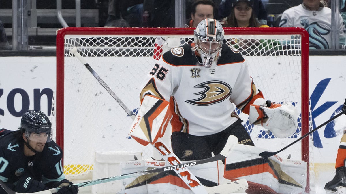 The puck sits in front of Anaheim Ducksgoalie John Gibson (36) and. Seattle Kraken forward Matty Beniers (10) during the first period at Climate Pledge Arena.