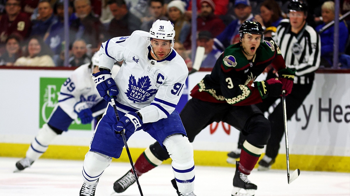oronto Maple Leafs center John Tavares (91) moves the puck against Arizona Coyotes defenseman Josh Brown (3) during the first period at Mullett Aren