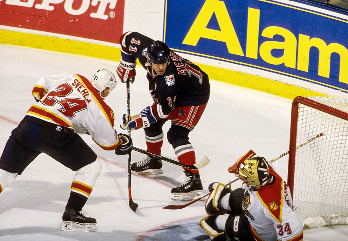 New York Rangers forward Mark Messier (11) in action against Florida Panthers defender Robert Svehla (24) and goalie John Vanbiesbrouck (34) during the 1996-97 season at Miami Arena.