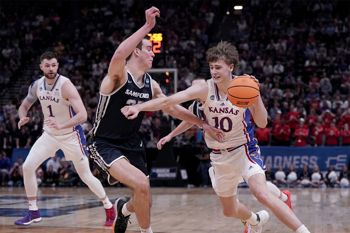 Mar 21, 2024; Salt Lake City, UT, USA; Kansas Jayhawks guard Johnny Furphy (10) drives against Samford Bulldogs center Riley Allenspach (35) during the second half in the first round of the 2024 NCAA Tournament at Vivint Smart Home Arena-Delta Center.