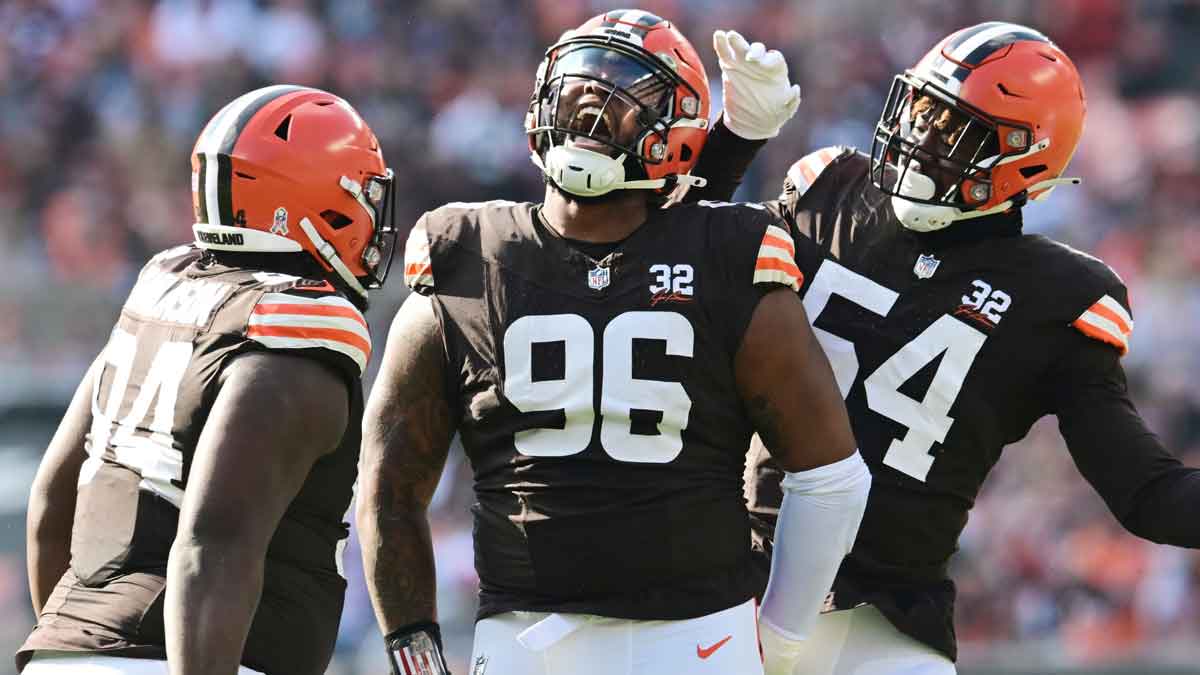 Nov 5, 2023; Cleveland, Ohio, USA; Cleveland Browns defensive tackle Jordan Elliott (96) celebrates a sack with defensive tackle Dalvin Tomlinson (94) and defensive end Ogbo Okoronkwo (54) during the first quarter against the Arizona Cardinals at Cleveland Browns Stadium.