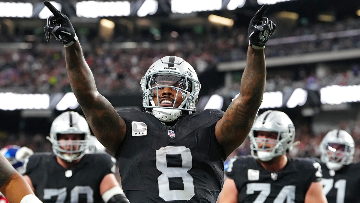 Las Vegas Raiders running back Josh Jacobs (8) celebrates after scoring a touchdown against the New York Giants during the second quarter at Allegiant Stadium.