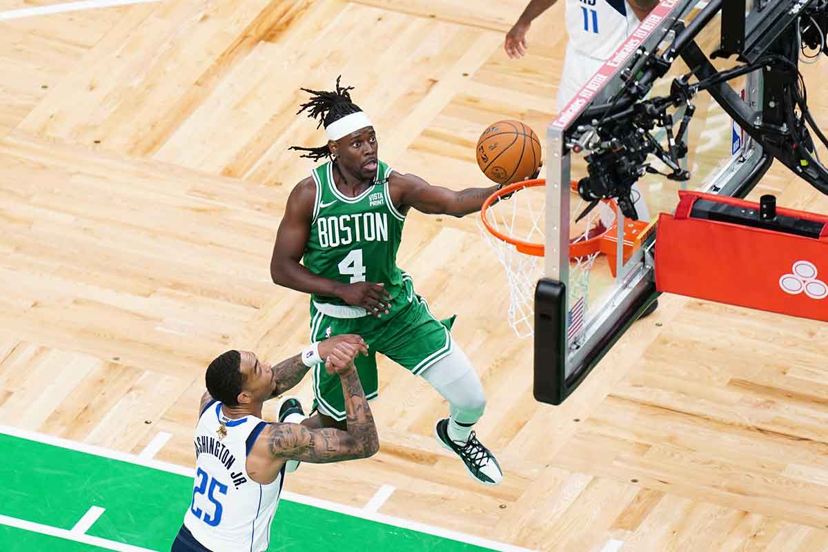 Boston Celtics guard Jrue Holiday (4) shoots against Dallas Mavericks forward P.J. Washington (25) in the third quarter during game five of the 2024 NBA Finals at TD Garden. 