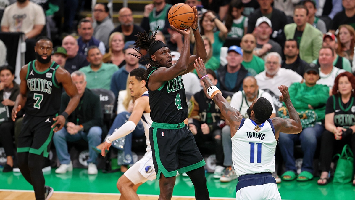 Boston Celtics guard Jrue Holiday (4) shoots the ball against Dallas Mavericks guard Kyrie Irving (11) during the second quarter in game two of the 2024 NBA Finals at TD Garden