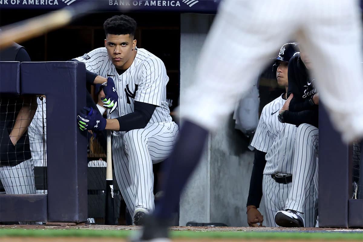 New York Yankees right fielder Juan Soto (22) watches from the top step of the dugout as third baseman DJ LeMahieu (26) bats during the ninth inning against the Los Angeles Dodgers at Yankee Stadium.