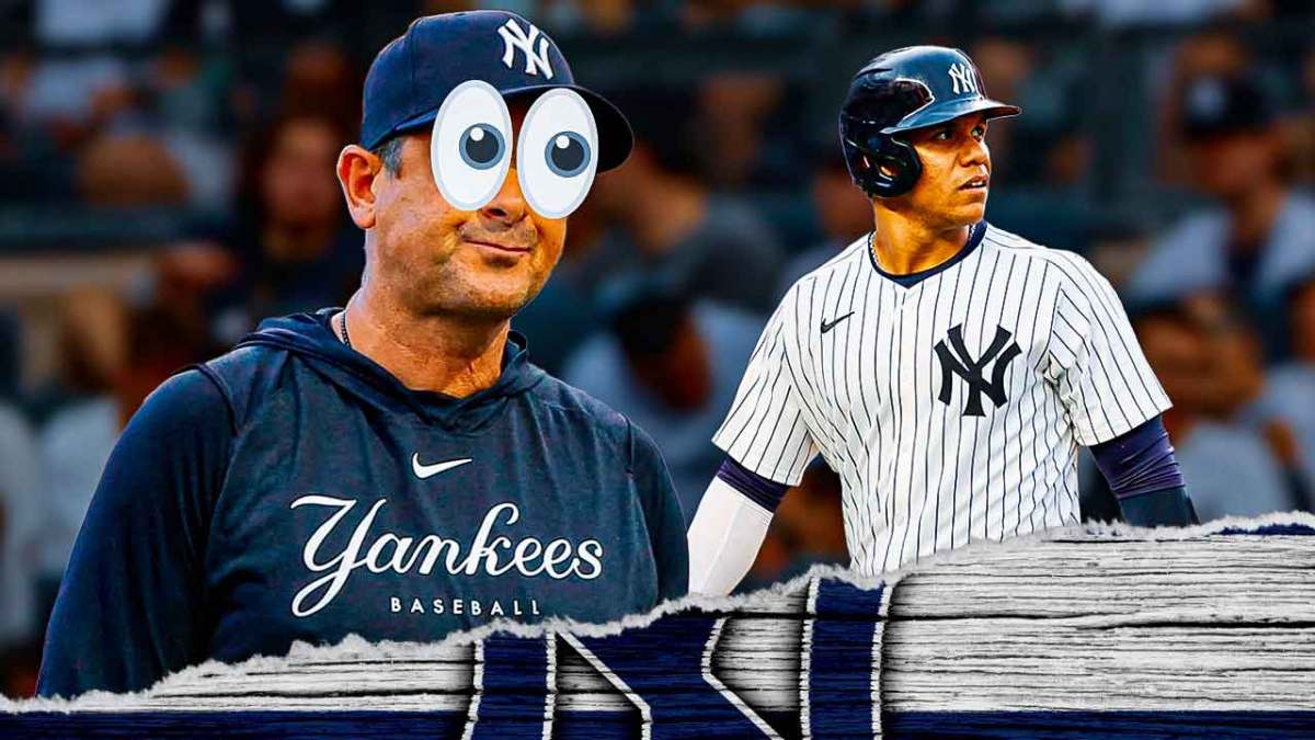Aaron Boone with big emoji eyes looking at Juan Soto.