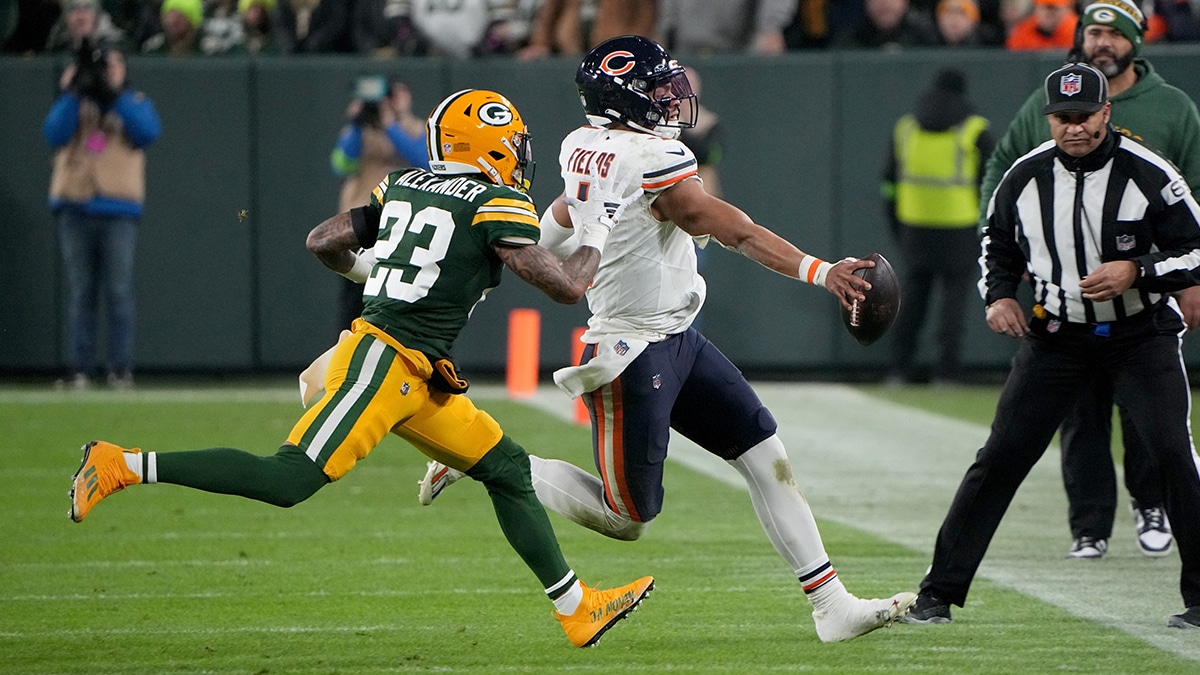 Green Bay Packers cornerback Jaire Alexander (23) runs Chicago Bears quarterback Justin Fields (1) out of bounds during the third quarter of their game Sunday, January 7, 2024 at Lambeau Field