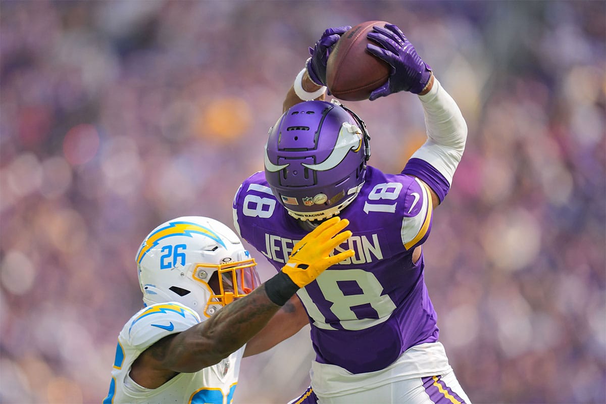 Minnesota Vikings wide receiver Justin Jefferson (18) catches a pass against the Los Angeles Chargers cornerback Asante Samuel Jr. (26) in the second quarter at U.S. Bank Stadium.