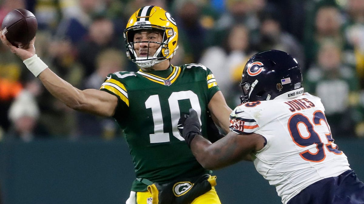 Green Bay Packers quarterback Jordan Love (10) throws under pressure from Chicago Bears defensive tackle Justin Jones (93) during their football game Sunday, January 7, 2024, at Lambeau Field in Green Bay, Wis. The Packers defeated the Bears 17-9.