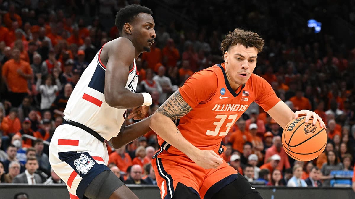 Illinois Fighting Illini forward Coleman Hawkins (33) dribbles the ball against the Connecticut Huskies in the finals of the East Regional of the 2024 NCAA Tournament at TD Garden.