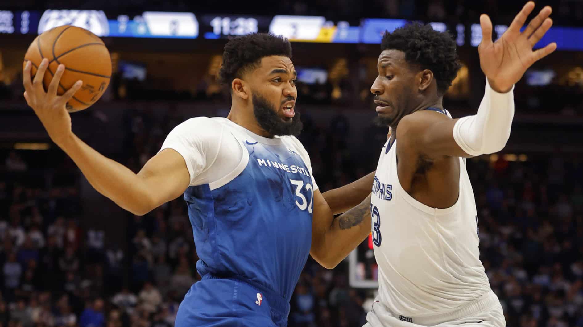 Minnesota Timberwolves forward Karl-Anthony Towns (32) goes against Memphis Grizzlies forward Jaren Jackson Jr. (13) in the first quarter at Target Center. 