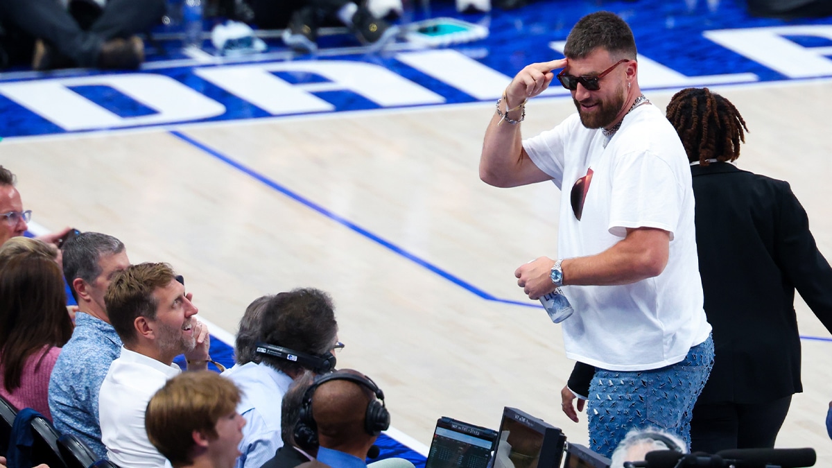 Kansas City Chiefs tight end Travis Kelce salutes the crowd in front of Dallas Mavericks former player Dirk Nowitzki during game three of the western conference finals for the 2024 NBA playoffs at American Airlines Center. Mandatory