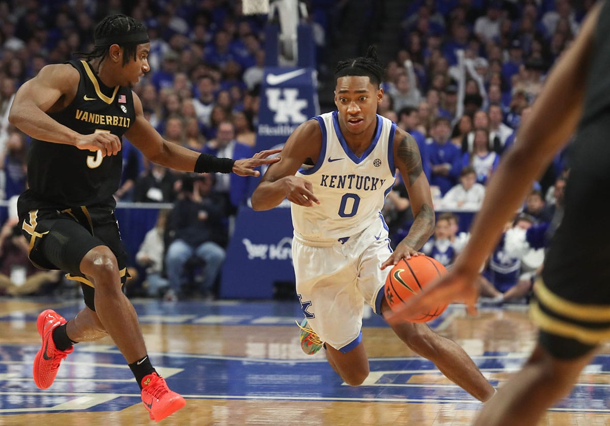 Kentucky's guard Rob Dillingham (0) drives past Vanderbilt's guard Ezra Manjon (5) during the first half of an NCAA basketball game at Rupp Arena in Lexington, Ky.