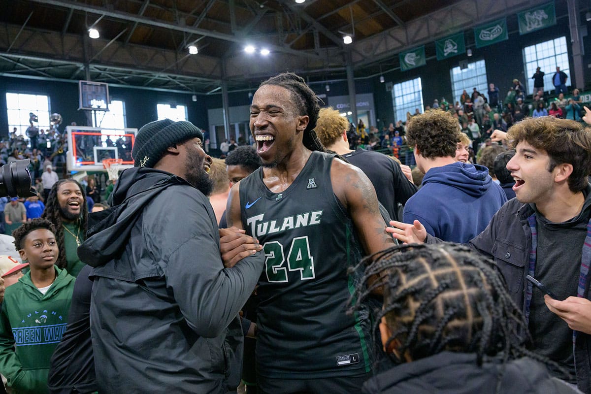 Tulane Green Wave forward Kevin Cross (24) and Tulane fans and students celebrate their victory against the Memphis Tigers at Avron B. Fogelman Arena in Devlin Fieldhouse.