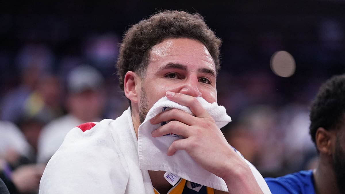 Golden State Warriors guard Klay Thompson (11) sits on the bench during action against the Sacramento Kings in the fourth quarter during a play-in game of the 2024 NBA playoffs at the Golden 1 Center. Mandatory Credit: Cary Edmondson-USA TODAY Sports