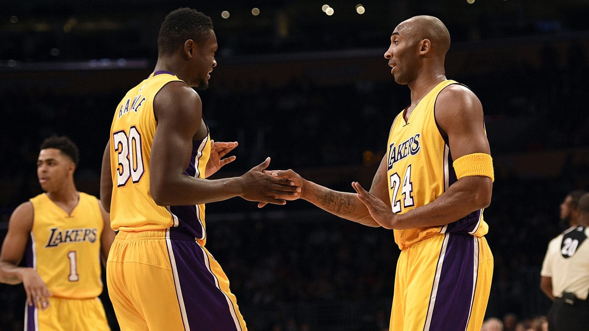 Los Angeles Lakers guard Kobe Bryant (right) high fives with Los Angeles Lakers forward Julius Randle (left) during the first quarter against the Toronto Raptors at Staples Center. 