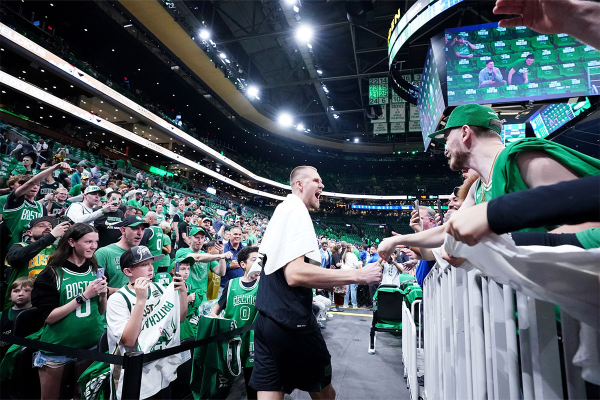 Boston Celtics center Kristaps Porzingis (8) greets fans before the game against the Dallas Mavericks in game one of the 2024 NBA Finals at TD Garden