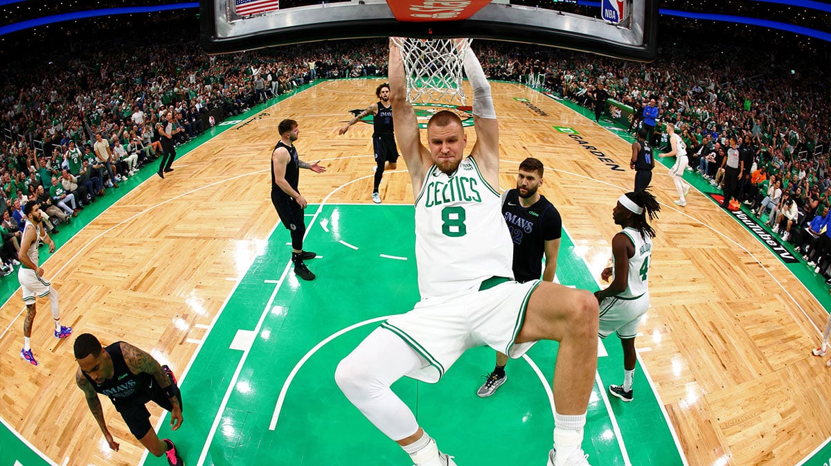 Boston Celtics center Kristaps Porzingis (8) dunks the ball against the Dallas Mavericks during the first quarter during game one of the 2024 NBA Finals at TD Garden. 