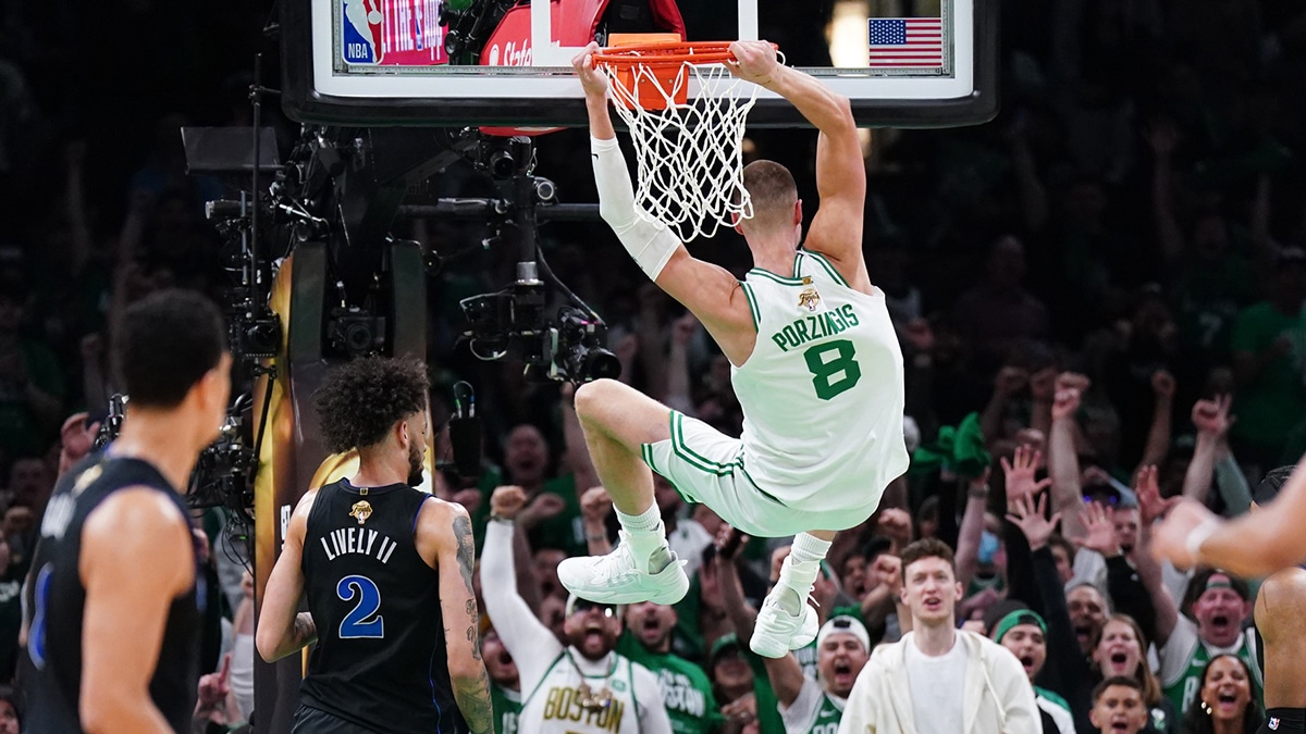 Boston Celtics center Kristaps Porzingis (8) dunks against the Dallas Mavericks in the first quarter during game one of the 2024 NBA Finals at TD Garden.