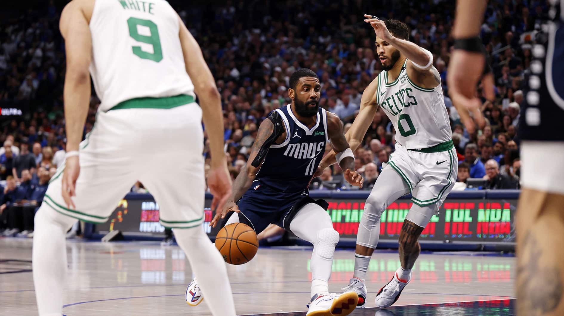 Jun 14, 2024; Dallas, Texas, USA; Dallas Mavericks guard Kyrie Irving (11) drives to the basket against Boston Celtics forward Jayson Tatum (0) during the third quarter during game four of the 2024 NBA Finals at American Airlines Center. Mandatory Credit: Peter Casey-USA TODAY Sports