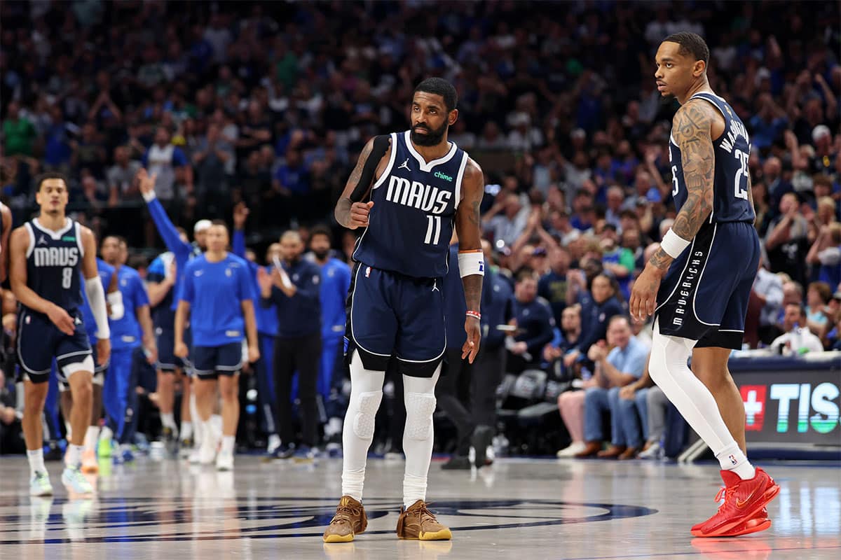 Dallas Mavericks guard Kyrie Irving (11) reacts after a play against the Boston Celtics during the fourth quarter during game three of the 2024 NBA Finals at American Airlines Center.