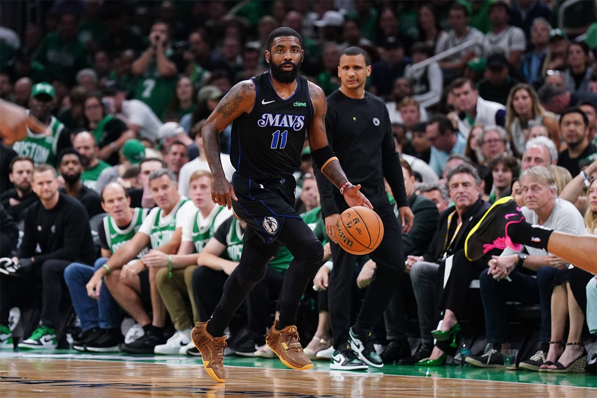 Dallas Mavericks guard Kyrie Irving (11) controls the ball against the Boston Celtics in the first quarter during game one of the 2024 NBA Finals at TD Garden.