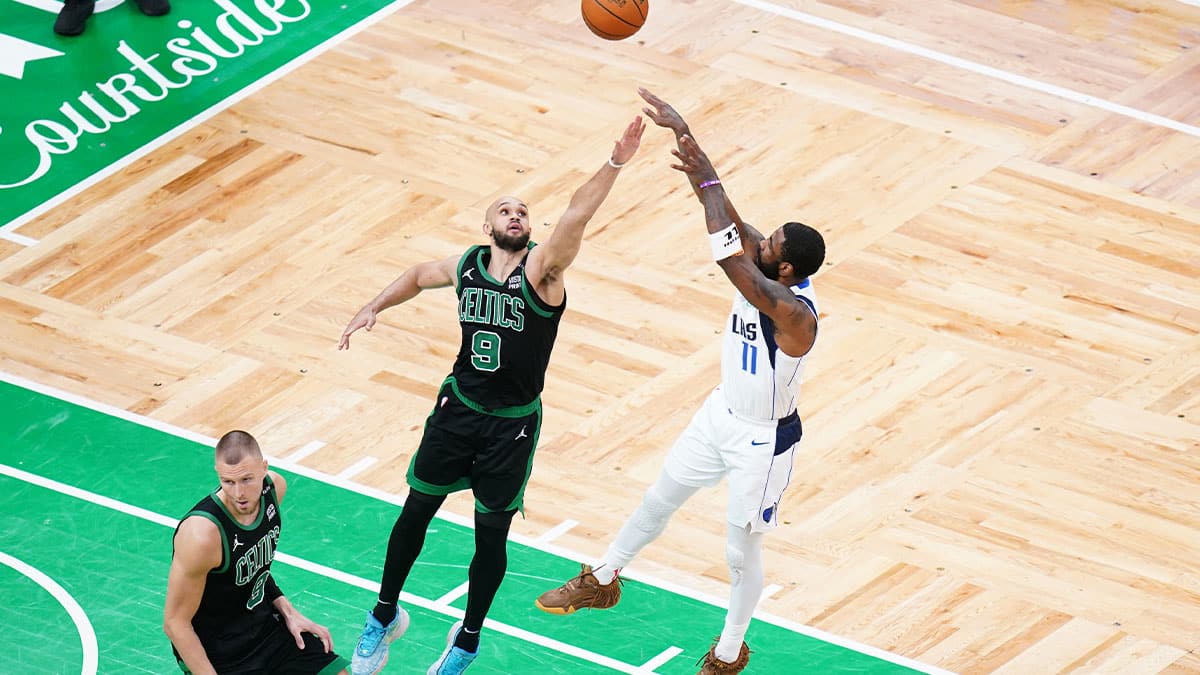 Dallas Mavericks guard Kyrie Irving (11) shoots against Boston Celtics guard Derrick White (9) in the third quarter during game two of the 2024 NBA Finals at TD Garden. 