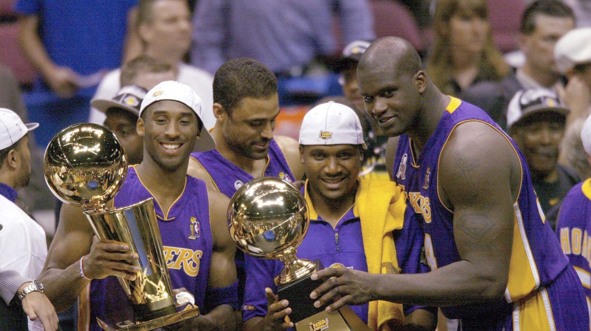 Lakers Kobe Bryant, Lindsay Hunter and Shaquille O'Neal hold championship trophies