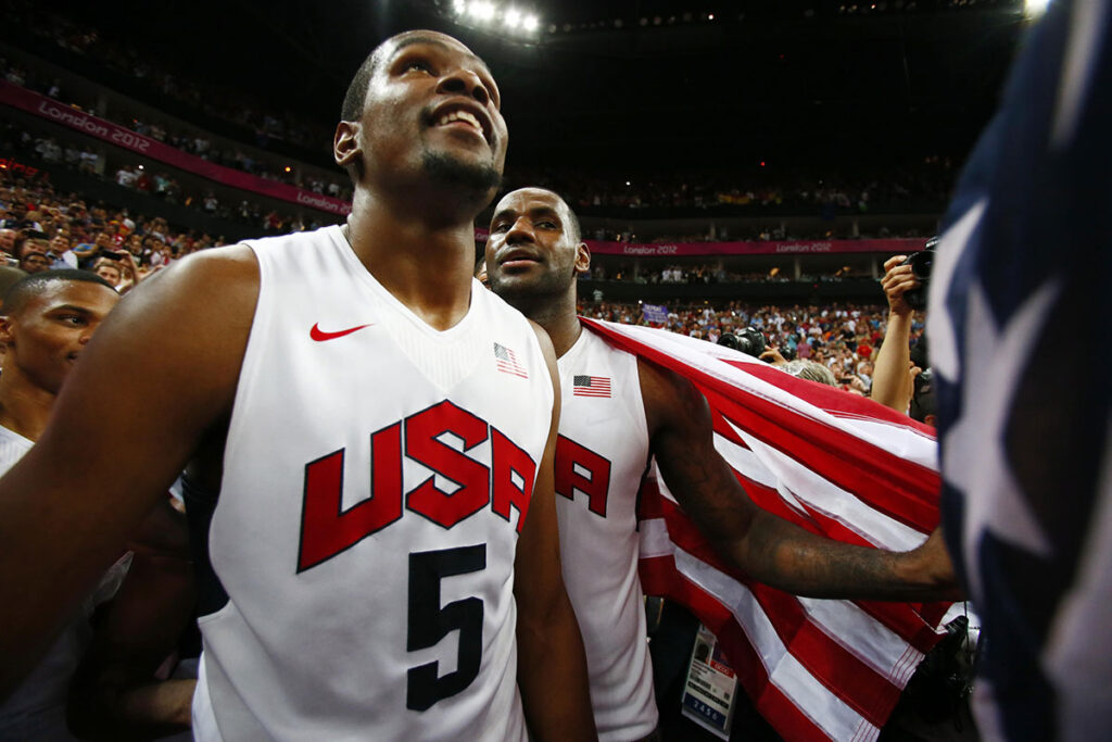 USA players Kevin Durant (5) and LeBron James (right) celebrate after defeating Spain 107-100 during the men's basketball gold medal game in the London 2012 Olympic Games at North Greenwich Arena. 