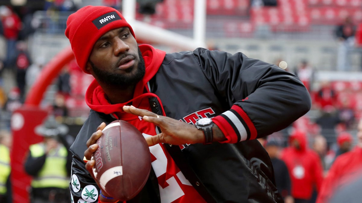 Cleveland Cavaliers player LeBron James plays catch with the Ohio State Buckeyes team before the game against the Michigan Wolverines at Ohio Stadium.