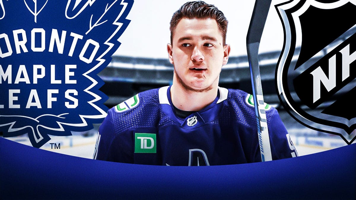 Canucks' Nikita Zadarov stands next to Maple Leafs logo before NHL Free agency