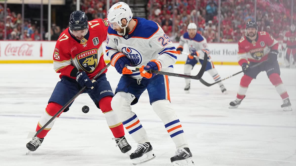 Florida Panthers forward Evan Rodrigues (17) battles for the puck against Edmonton Oilers forward Leon Draisaitl (29) during the second period in game five of the 2024 Stanley Cup Final at Amerant Bank Arena.
