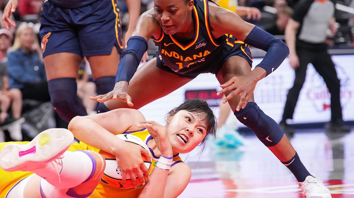Indiana Fever center Temi Fagbenle (14) reaches for the ball against Los Angeles Sparks center Li Yueru (28) on Tuesday, May 28, 2024, during the game at Gainbridge Fieldhouse in Indianapolis. The Los Angeles Sparks defeated the Indiana Fever, 88-82.
