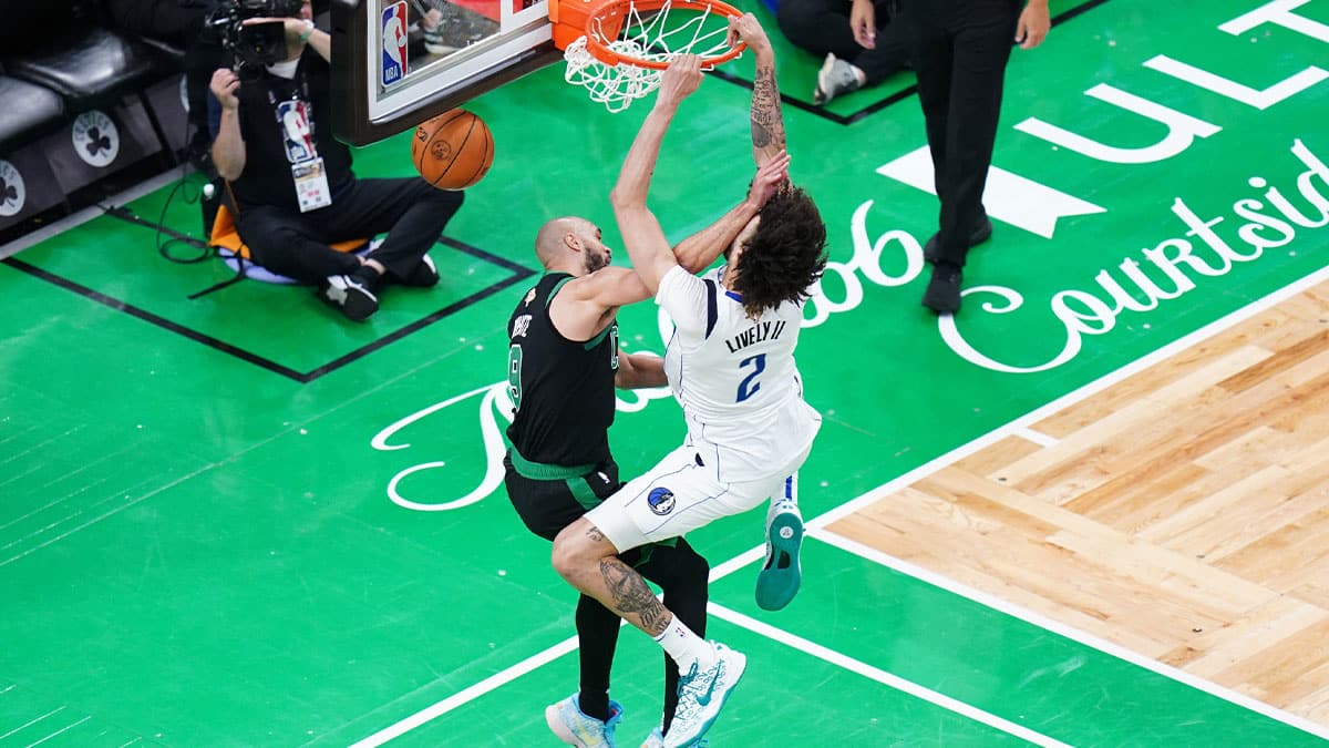  Dallas Mavericks center Dereck Lively II (2) shoots against Boston Celtics guard Derrick White (9) in the third quarterduring game two of the 2024 NBA Finals at TD Garden.