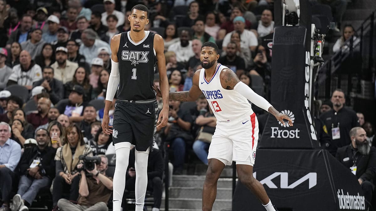 Los Angeles Clippers forward Paul George (13) defends San Antonio Spurs forward Victor Wembanyama (1) during the first half at Frost Bank Center. 