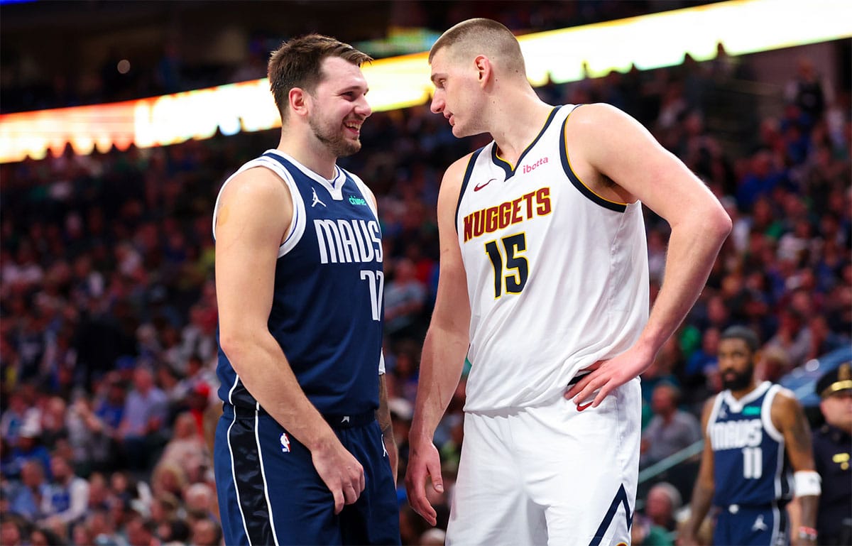 Dallas Mavericks guard Luka Doncic (77) speaks with Denver Nuggets center Nikola Jokic (15) during the second half at American Airlines Center.