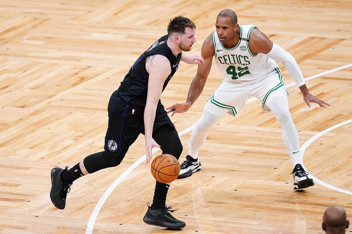 Dallas Mavericks guard Luka Doncic (77) controls the ball against Boston Celtics center Al Horford (42) in the fourth quarter during game one of the 2024 NBA Finals at TD Garden.