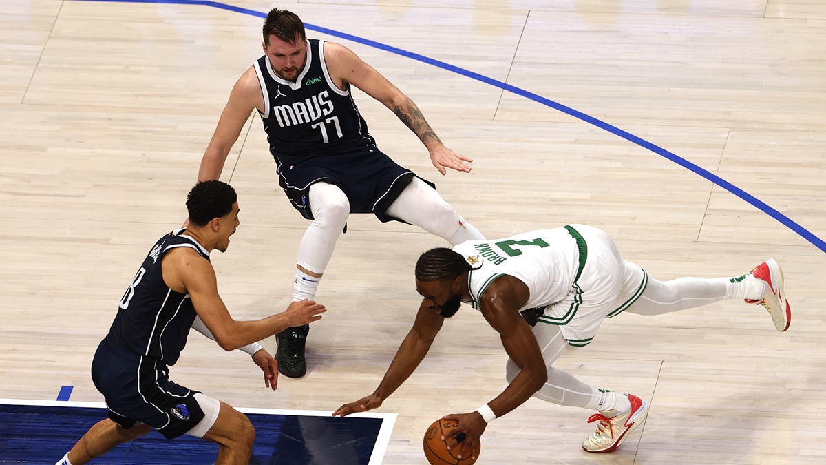 Dallas Mavericks guard Luka Doncic (77) is called for a blocking foul against Boston Celtics guard Jaylen Brown (7) to foul out during the fourth quarter in game three of the 2024 NBA Finals at American Airlines Center.